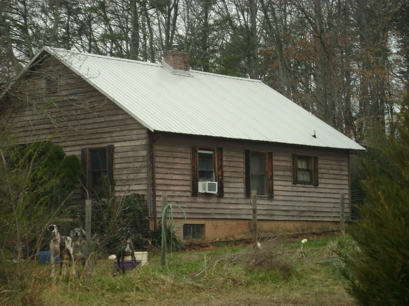 White metal roof on an old wood sided farmhouse, from a Metal Roof Installation job in New Straitsville